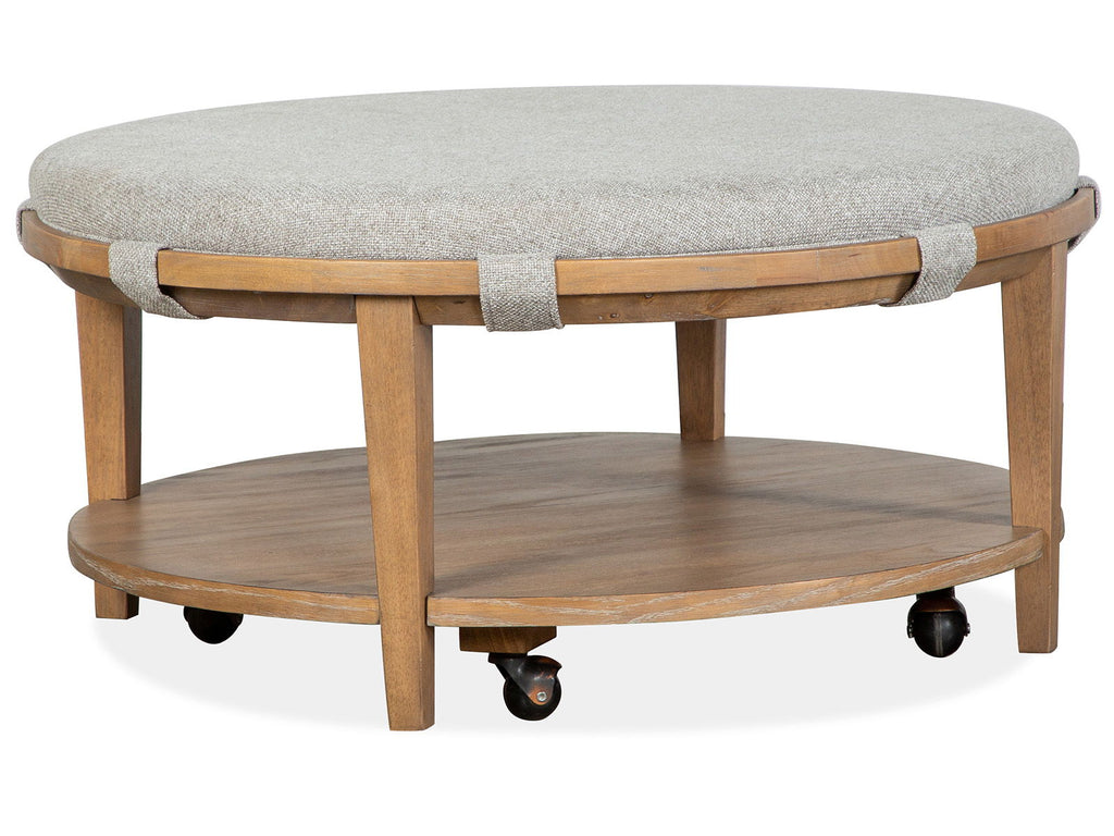 Lindon - Round Cocktail Table With Gray Upholstered Top & Casters - Belgian Wheat